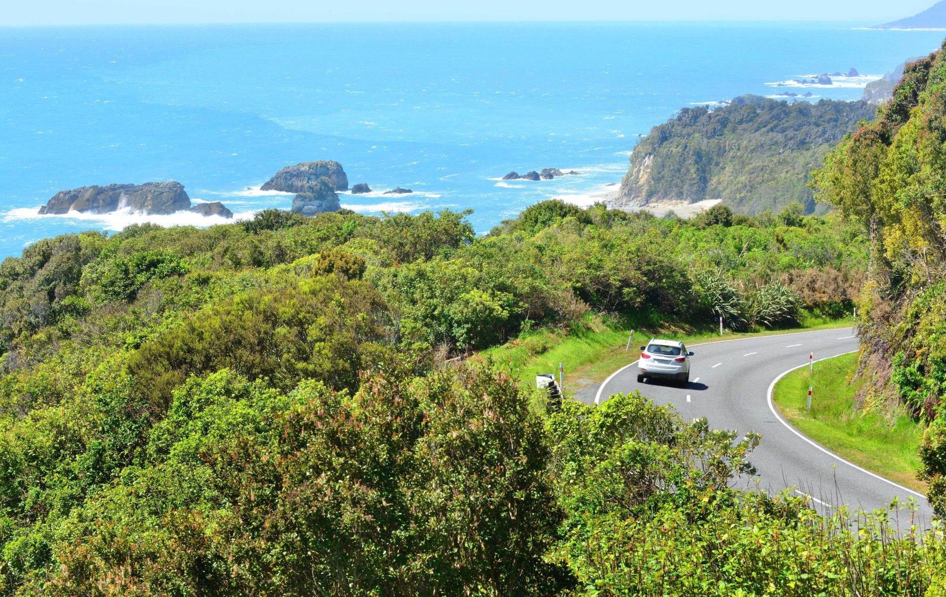 Driving along New Zealand Coast in Rental Car